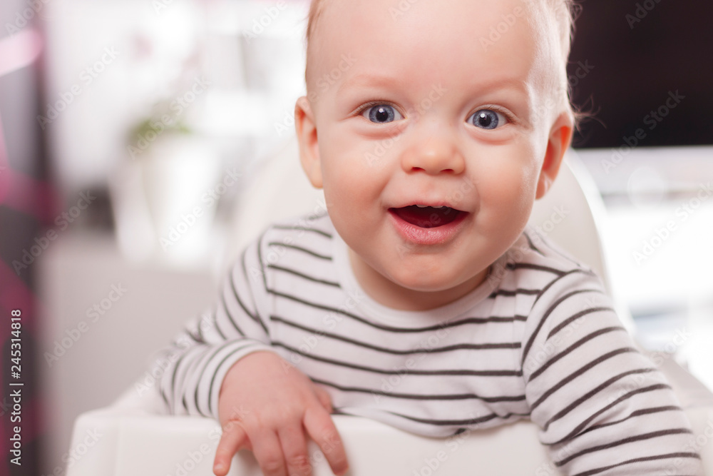 Portrait of Cute adorable baby boy smiling and looking at camera.