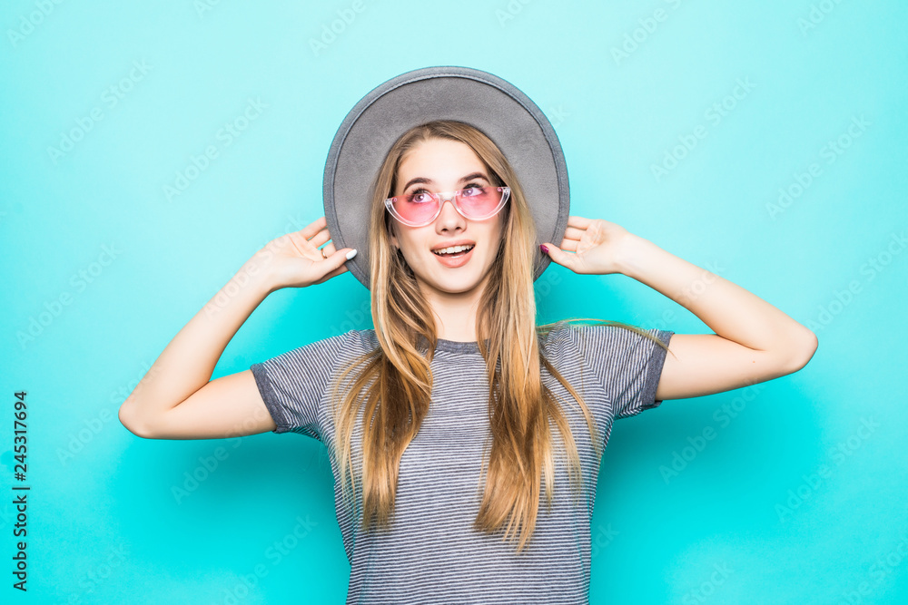 Trendy sexy young woman wearing casual clothes posing over green background Trendy sexy young woman wearing casual clothes posing over green background