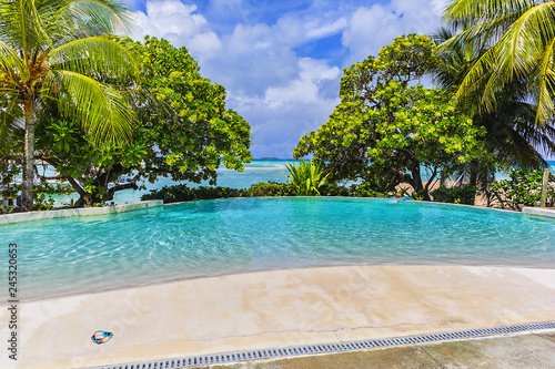 Fototapeta Naklejka Na Ścianę i Meble -  Coastline with a tropical beach and the turquoise water of the inner lagoon of the atoll of Tikehau at sunny day. Tuamotus archipelago, French Polynesia, south Pacific ocean.