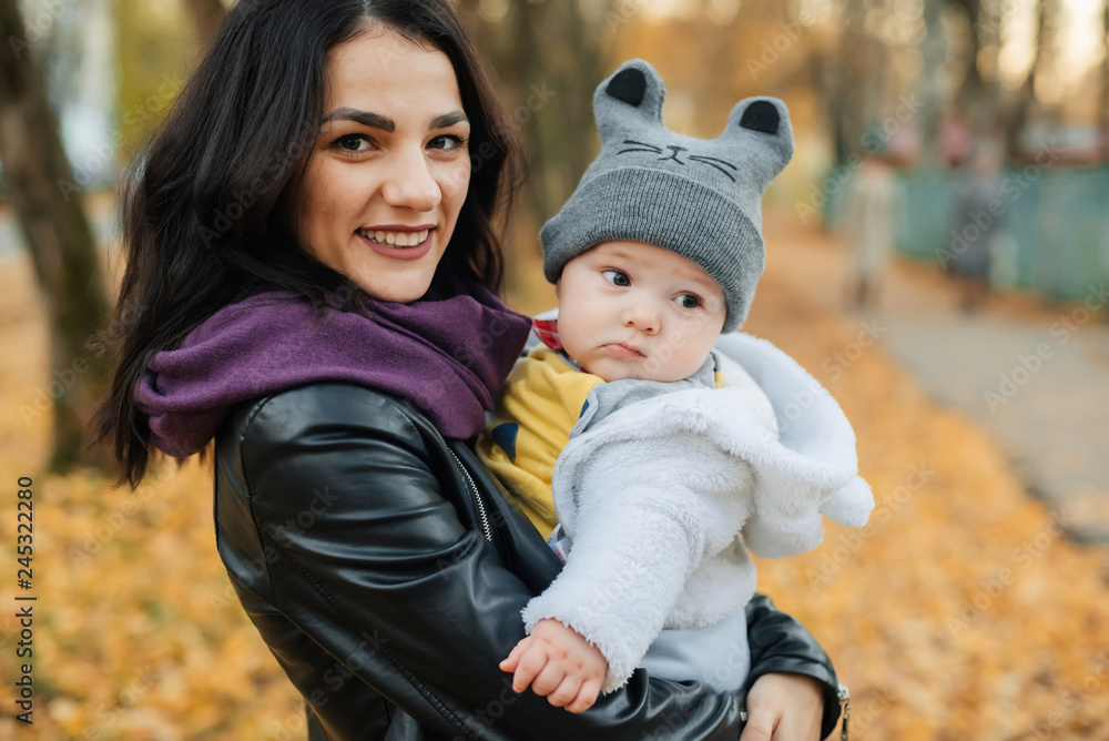 Fototapeta premium young beautiful Caucasian girl mom holding her little boy baby son