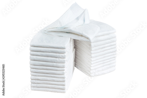 Stack of adult disposable diapers isolated on white background. Health care for elderly and bedridden people with urinary incontinence