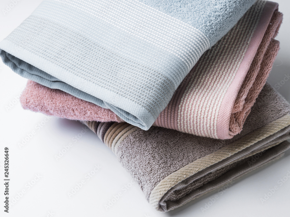 Pastel color clean folded towels on white