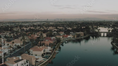Aerial drone flight over Las Vegas suburb on lake