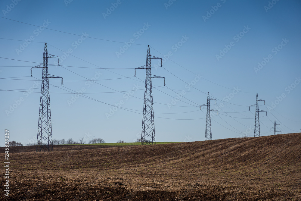 cultivated field and poles of electric current