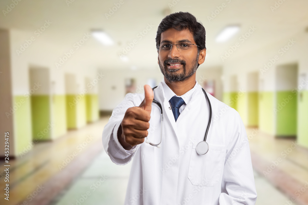 Doctor holding thumb up as like gesture.