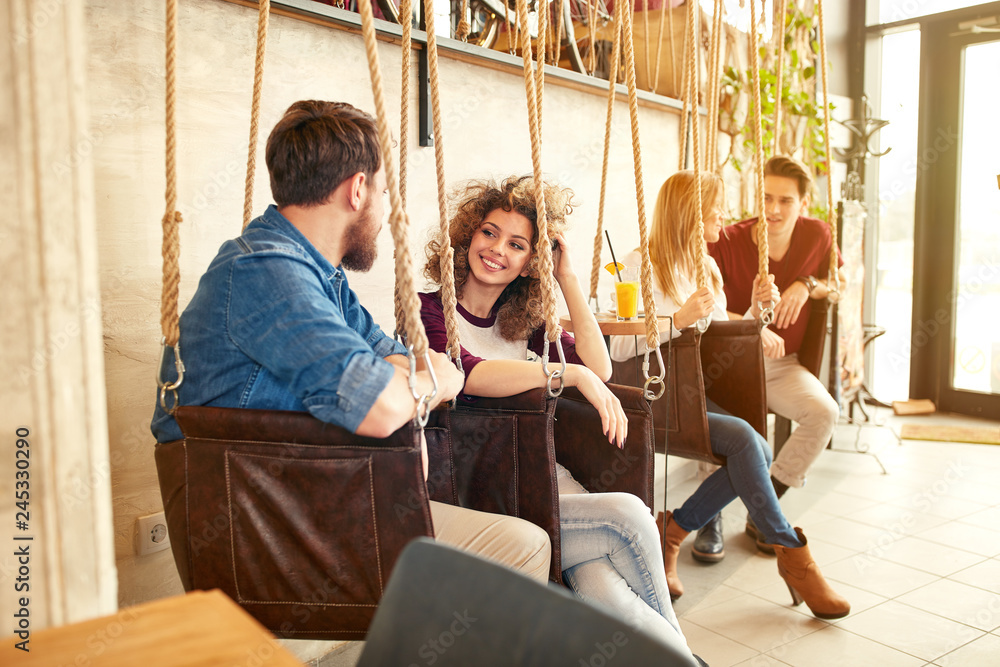 Men and women talking on swing Men and women talking on swing