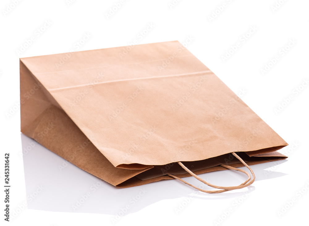 One Empty Brown Paper Bag. Recycled paper Shopping Bag isolated on white background. One Empty Brown Paper Bag. Recycled paper Shopping Bag isolated on white background.
