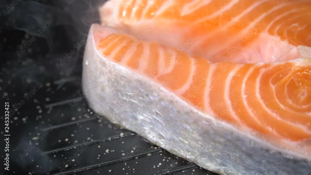 Salmon steak fried in a pan. Slow motion Salmon steak fried in a pan. Slow motion