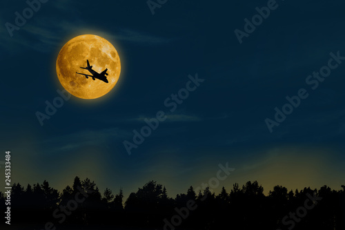 silhouette of airplane fly over on moon backgtound in blue sky