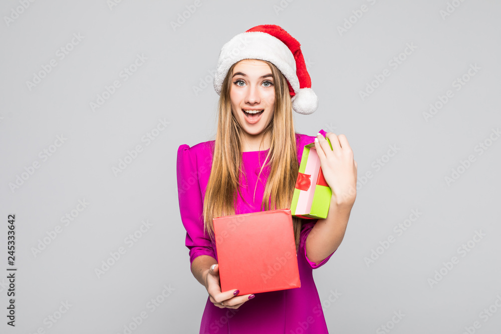 Christmas, x-mas, winter, happiness concep. Smiling woman in santa helper hat with gift box isolated on white background Christmas, x-mas, winter, happiness concep. Smiling woman in santa helper hat with gift box isolated on white background