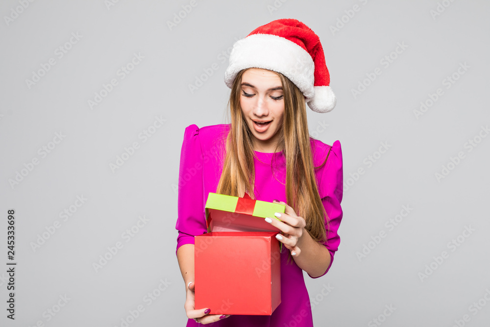 Christmas, x-mas, winter, happiness concep. Smiling woman in santa helper hat with gift box isolated on white background Christmas, x-mas, winter, happiness concep. Smiling woman in santa helper hat with gift box isolated on white background
