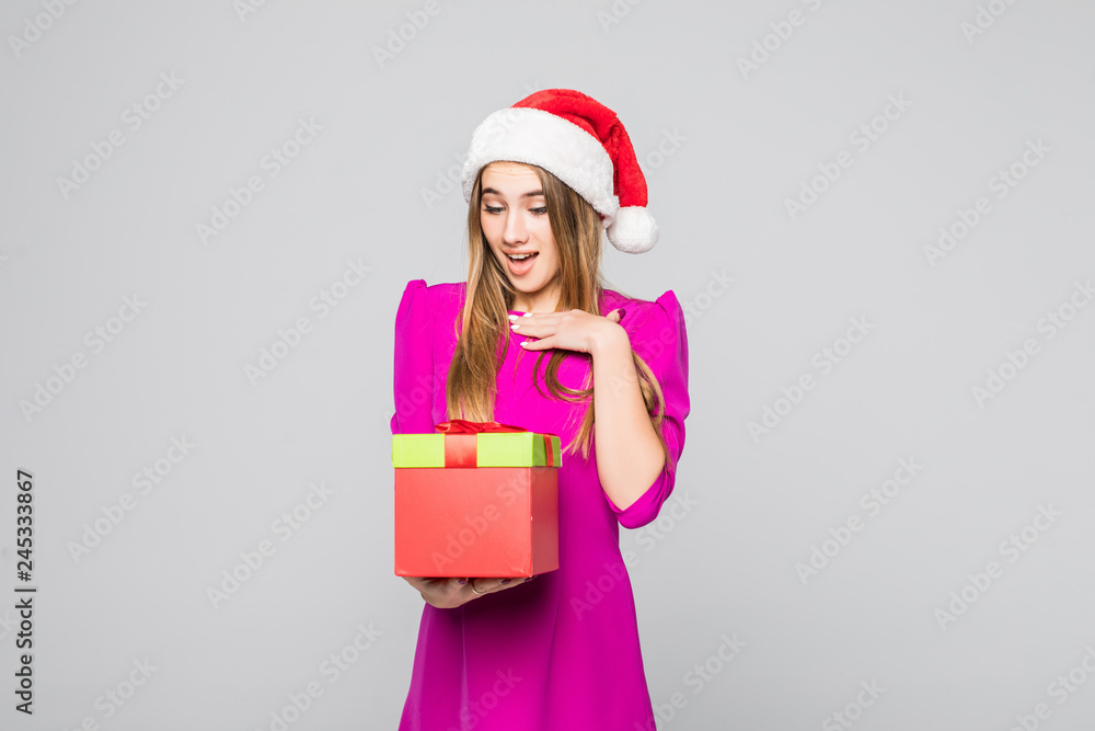 Young woman in dress holding gift box isolated on white background. Smiling christmas girl isolated portrait. Young woman in dress holding gift box isolated on white background. Smiling christmas girl isolated portrait.