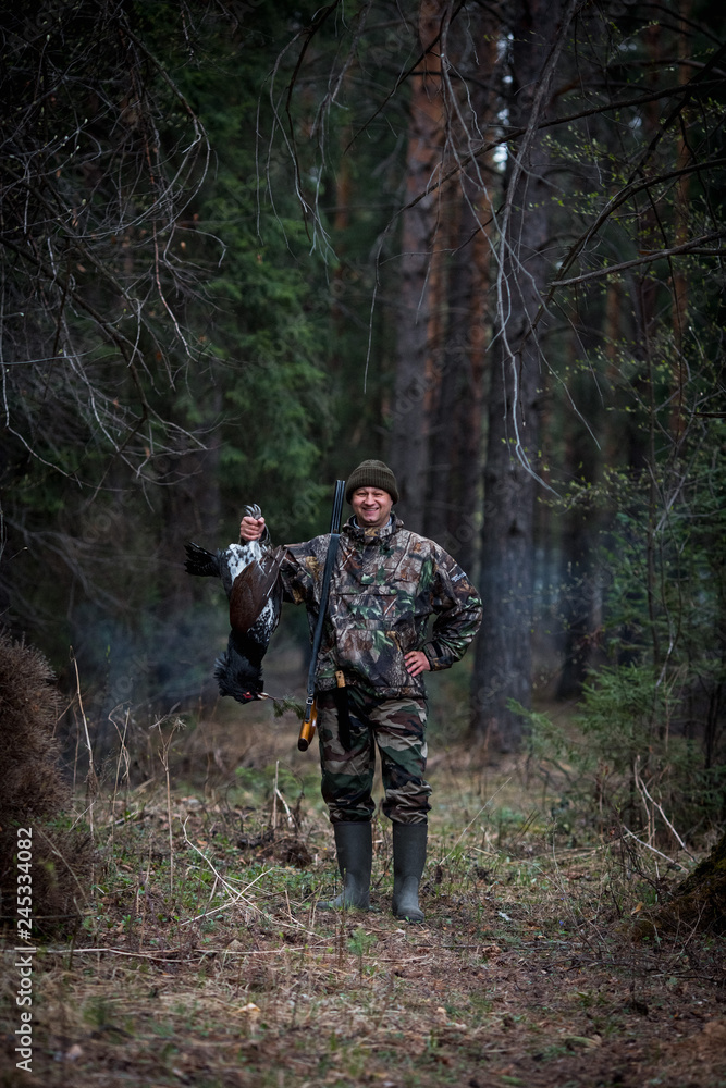 grouse hunter in the forest with prey