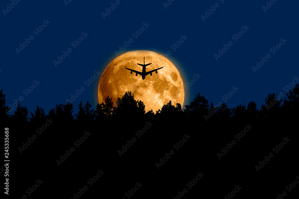 silhouette of airplane fly on moon backgtound in blue sky