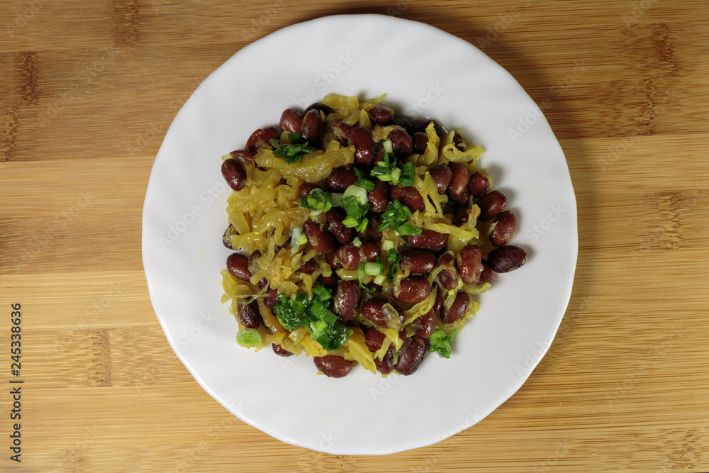 Stewed red beans with fried onions. Vegan food - red and black beans with fried onions, fried on an olive oil. Stewed red beans with fried onions. Vegan food - red and black beans with fried onions, fried on an olive oil.