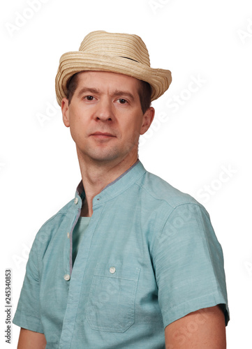 The man's portrait in a shirt and a hat on the head