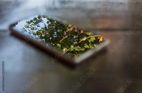phone on wooden table screen in focus background artistic