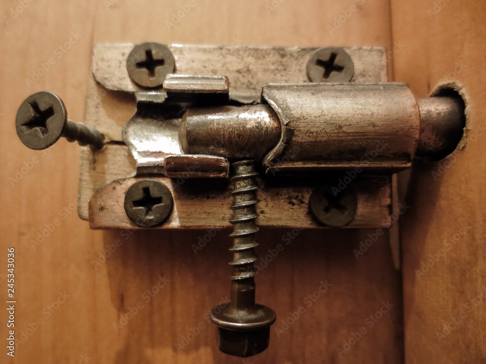 Old metal bolt on the door. Door with old iron lock Old metal bolt on the door. Door with old iron lock