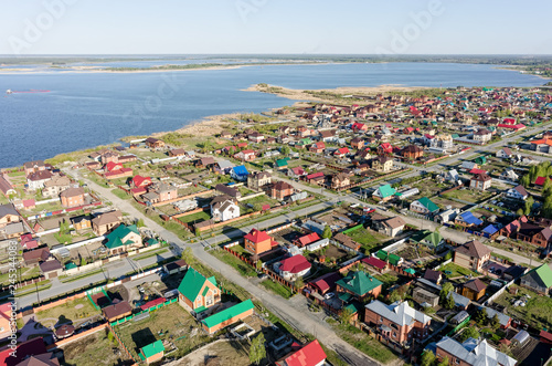 Aerial view onto private houses on bank of lake