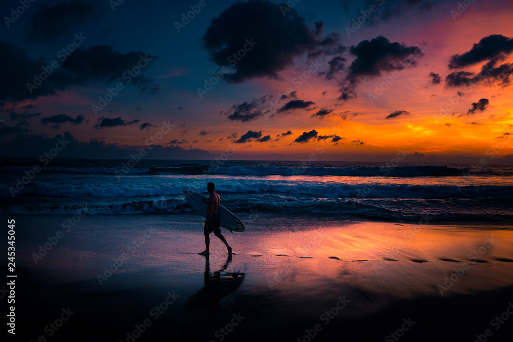 Surfer at the beach during sunset