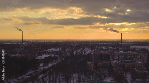 Plant industrial pipes with smoke at the sunset background. Ecological pollution conseptual video background photo