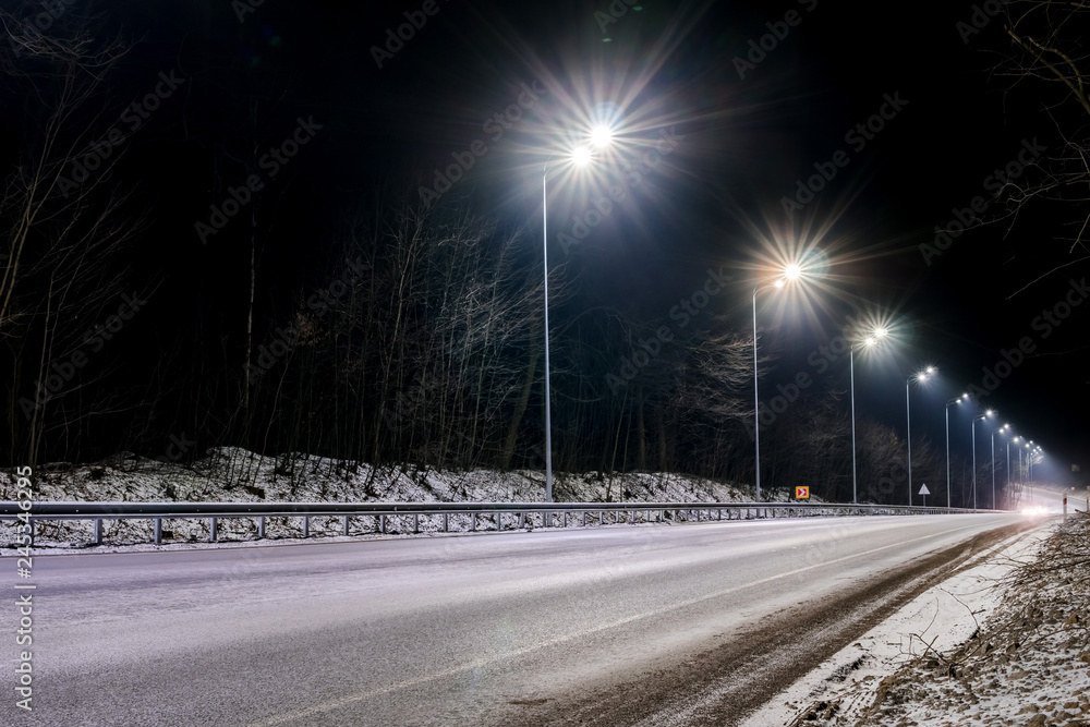street lighting, supports for ceilings with led lamps. concept of modernization and maintenance of lamps, place for text, night. winter season. energy-saving lamps, safety of movement - obrazy, fototapety, plakaty 