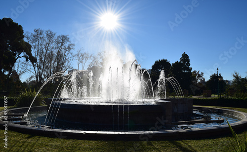 The Sun Shines Behind a Water Fountain 2
