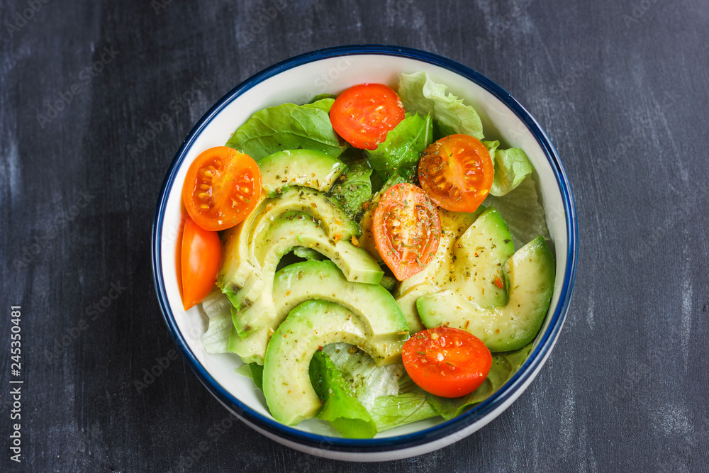 Vegetarian salad with avocado, arugula, cherry tomatoes and herbs. Vegetarian salad with avocado, arugula, cherry tomatoes and herbs.