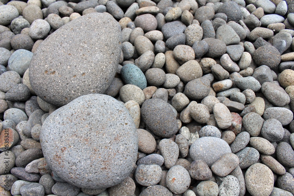 Big stones among smaller pebbles, in the garden. Big stones among smaller pebbles, in the garden.