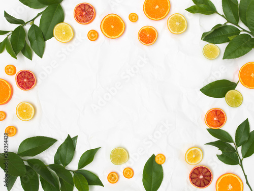 Fototapeta Naklejka Na Ścianę i Meble -  many different fresh citrus fruits on white crumpled paper background