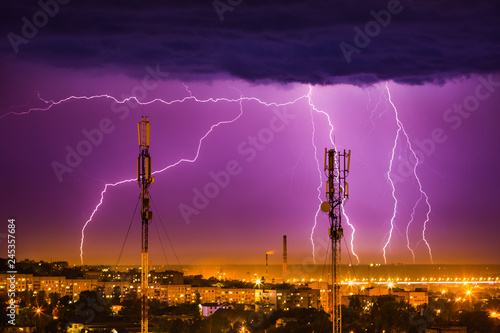 storm lightning on the horizon over telephone towers