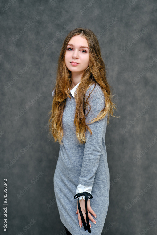 Concept Portrait of a pleasant friendly manager of a happy brunet girl with beautiful long hair. Concept Portrait of a pleasant friendly manager of a happy brunet girl with beautiful long hair.