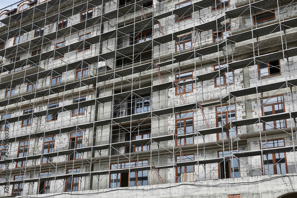 new building under construction, scaffolding and concrete new building under construction, scaffolding and concrete