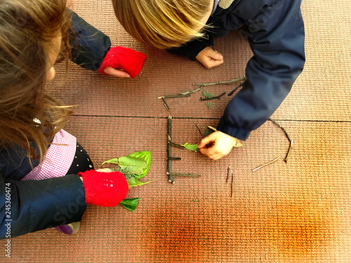 little children playing, expolring and gardening in the garden,  learning by doing, education and play in the nature concept - space for writing photo
