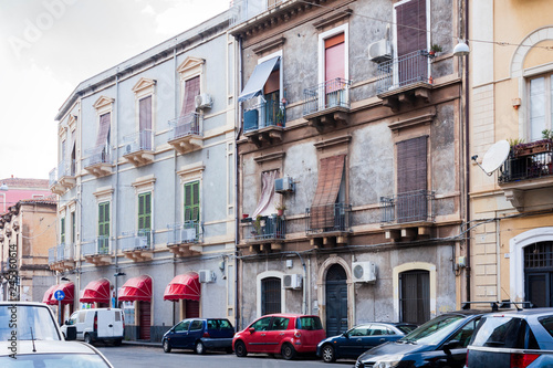 Travel to Italy -  historical street of Catania, Sicily, facade of ancient buildings. © Inna
