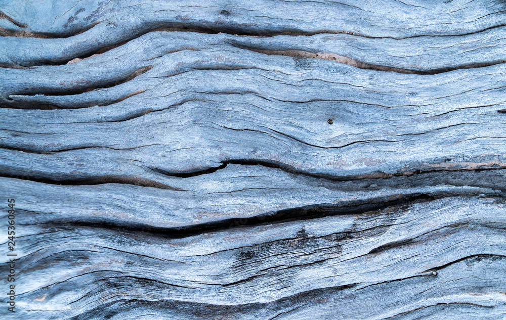 Close up and top view. The surface of old wooden board is patterned and cracked with grunge stain. Close up and top view. The surface of old wooden board is patterned and cracked with grunge stain.