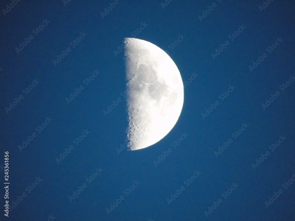 Genova, Italy - 10/24/2018: An amazing photography of the full moon over the city of Genova by night with a great clear sky in background and some stars using high zoom. Genova, Italy - 10/24/2018: An amazing photography of the full moon over the city of Genova by night with a great clear sky in background and some stars using high zoom.