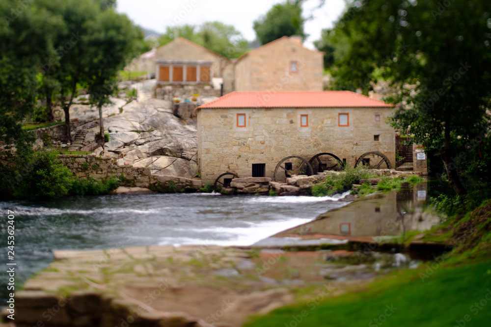 Obraz premium A picture with a Tilt and shift lens of a mill-house in Vilar de Mouros, Portugal.