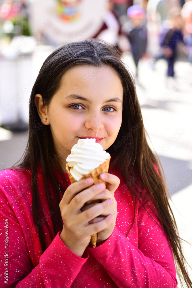 Yum yum. Pretty girl hold ice cream cone on summer day. Happy girl child  eating ice