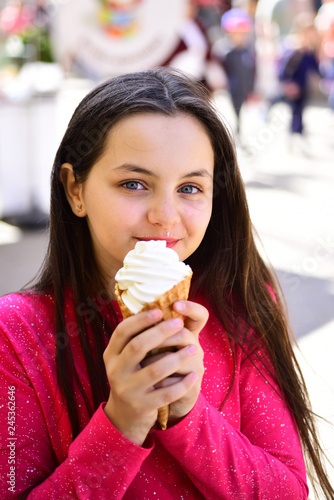 Yum yum. Pretty girl hold ice cream cone on summer day. Happy girl child eating ice cream in hot weather. Cute girl smiling with ice cream. Enjoying frozen food snack or dessert