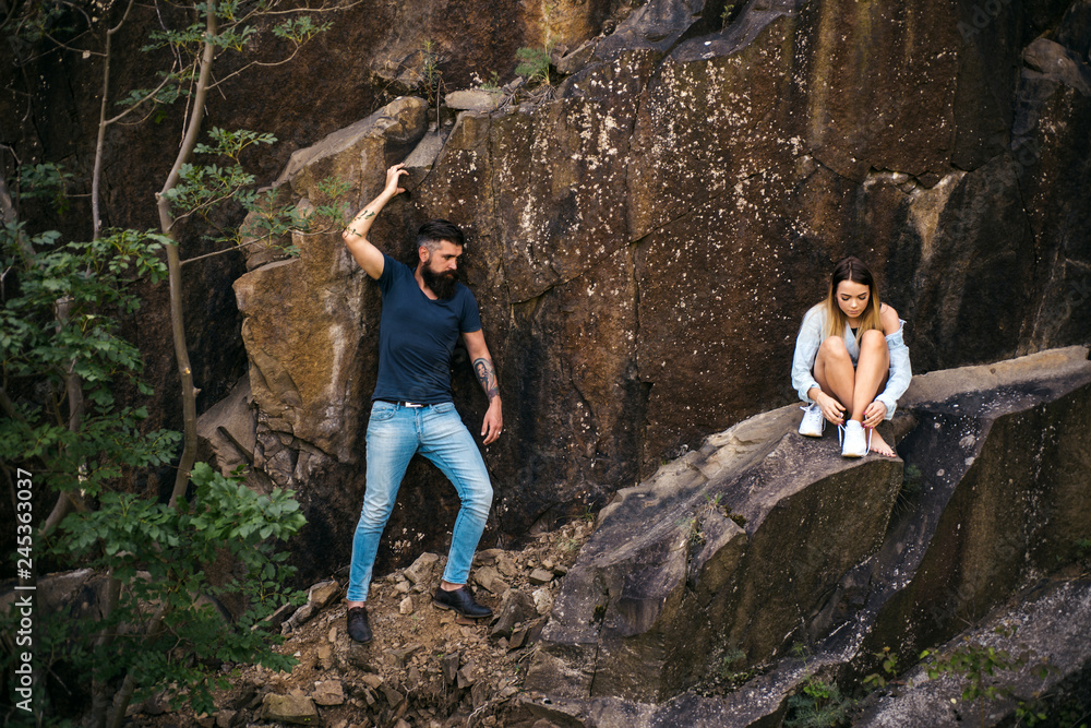 Feeling tired after a long travel. Couple enjoy love and romance. Sensual couple on vacation trip. Couple in love on summer vacation. Sexy woman and bearded man on natural landscape