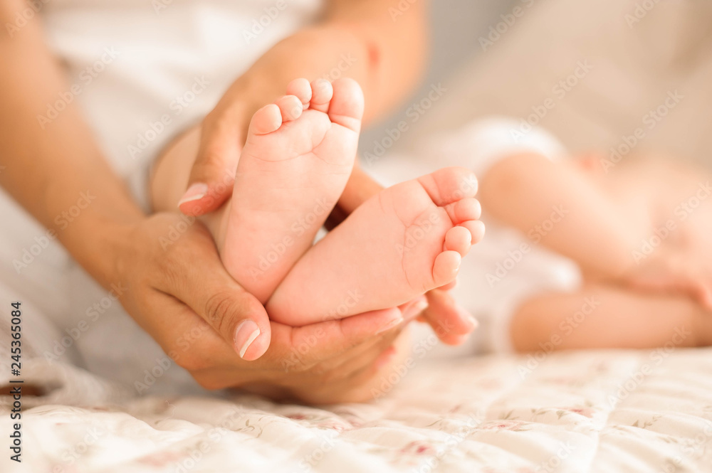 little baby feet in his mom's hands little baby feet in his mom's hands