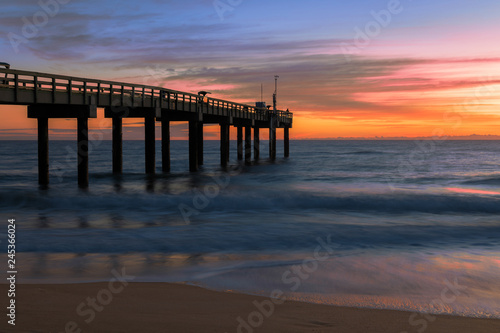 Sunrise over the Atlantic Ocean at the St. Augustine Beach Pier in St. Augustine, Florida © gnagel