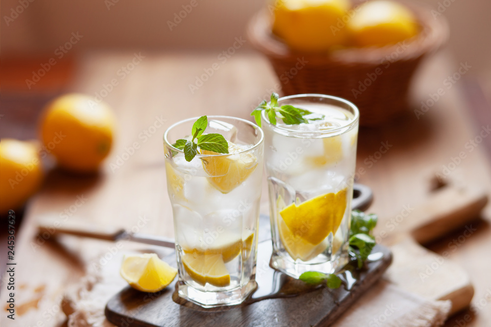 Refreshing summer drink with lemon, mint and ice copy space Refreshing summer drink with lemon, mint and ice copy space