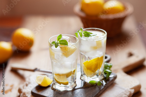 Refreshing summer drink with lemon, mint and ice copy space