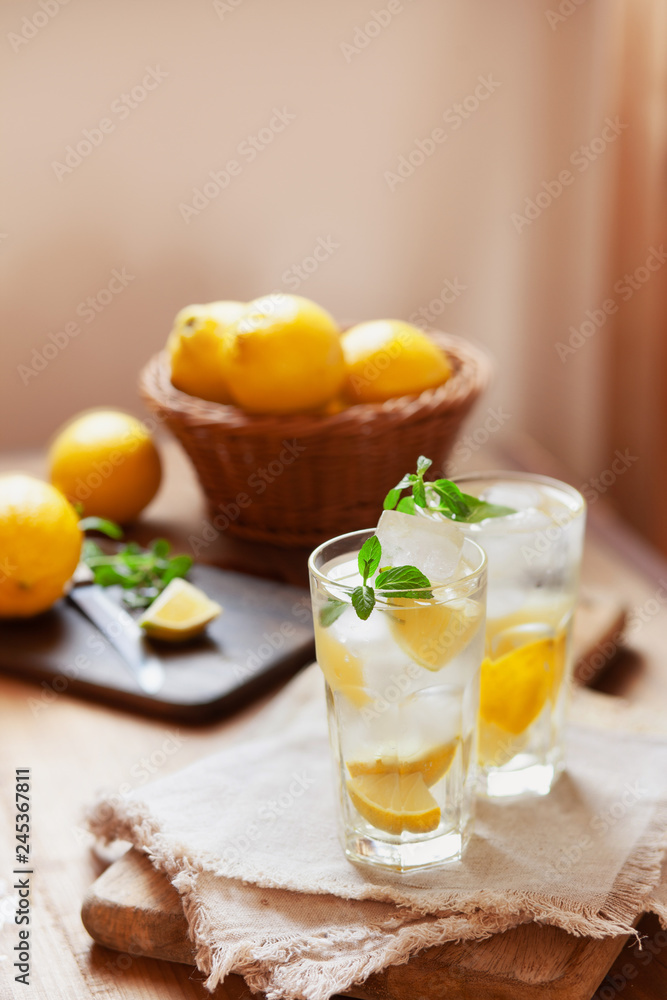 Refreshing summer drink with lemon, mint and ice copy space Refreshing summer drink with lemon, mint and ice copy space
