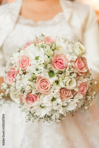 beautiful wedding bouquet pastel pink rose and white foliage 