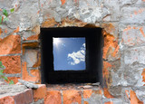 sky hole in a piece of a brick wall