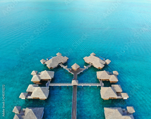 Aerial view of overwater bungalows with thatched roofs in the Bora Bora lagoon in French Polynesia photo