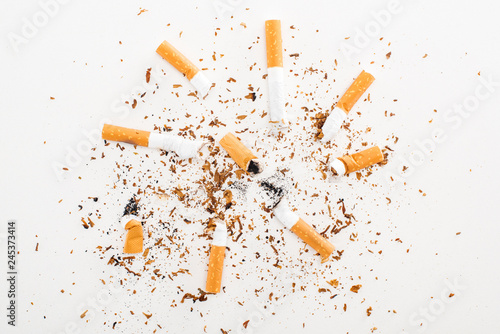 Studio shot of cigarette butts and tobacco isolated on white, stop smoking concept